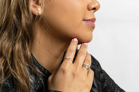 Close-up of a woman showing stylish rings and earrings, highlighting Jewelry for Summer trends