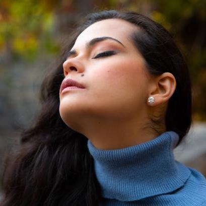 Elegant Moony Studs earrings from Luisana Jewelry showcased on a model with a serene expression