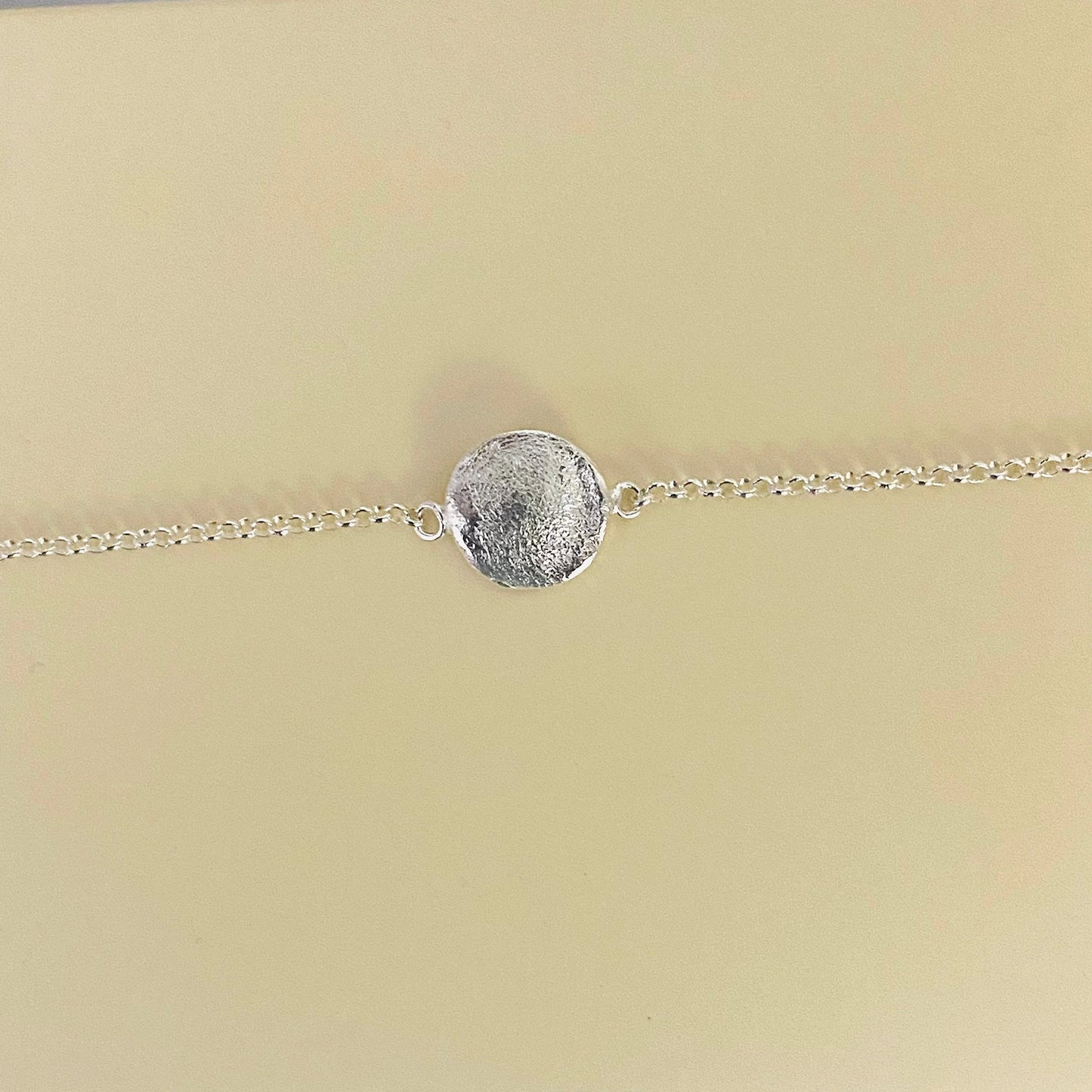 Delicate Luisana Jewelry Organic Love Bracelet with a textured circular pendant in silver