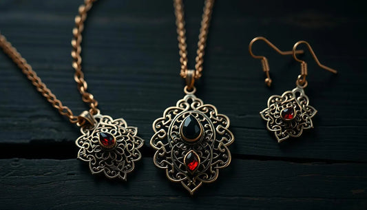 Intricate artisan jewelry set with detailed metalwork and red and black gemstone accents on necklace and earrings