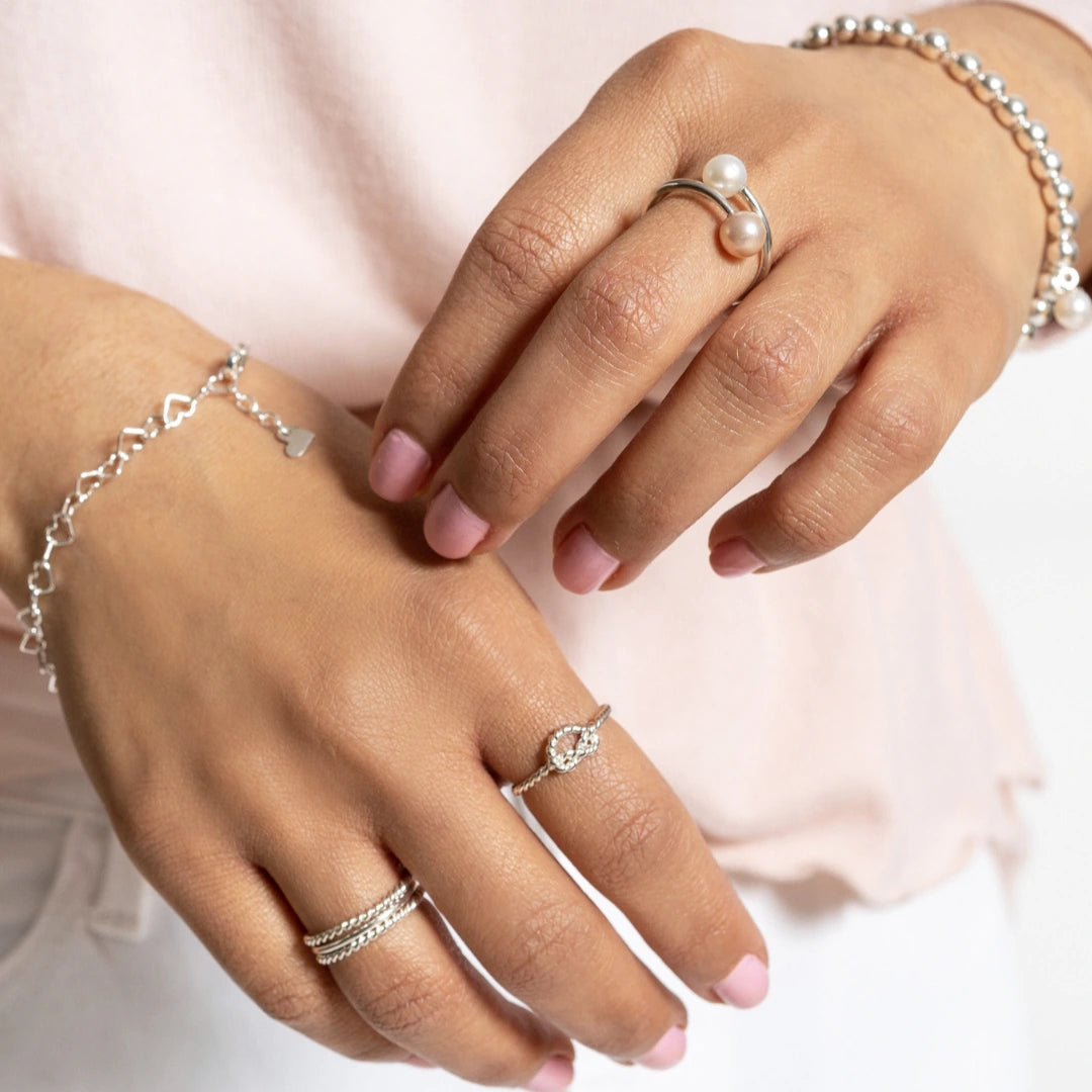 Luisana Jewelry Heart Bracelet in silver, paired with other elegant stacked rings and bracelets
