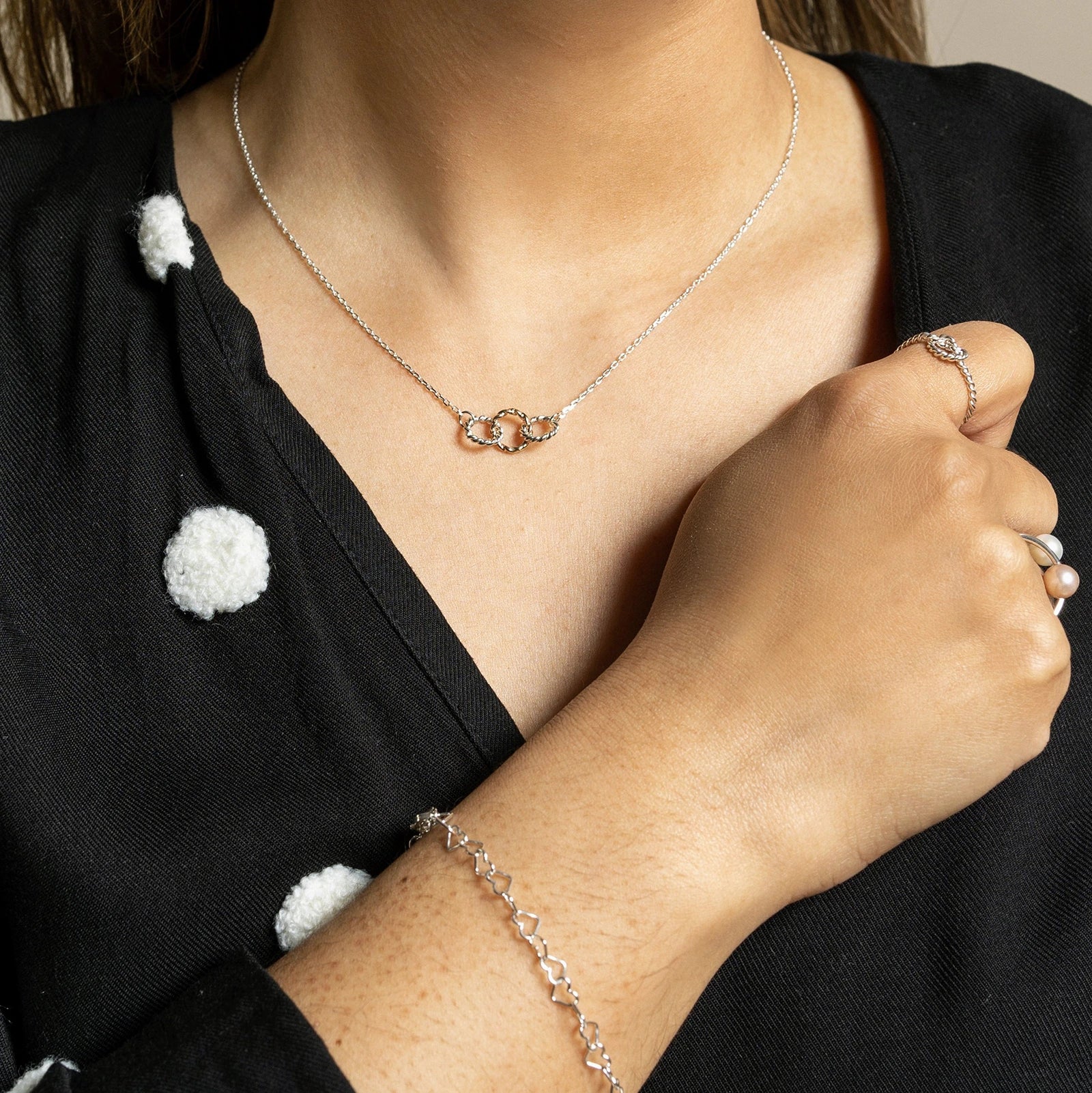 Silver Heart Bracelet by Luisana Jewelry, elegantly worn on the wrist with matching accessories