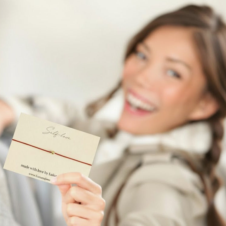 red bracelet with solid gold bead