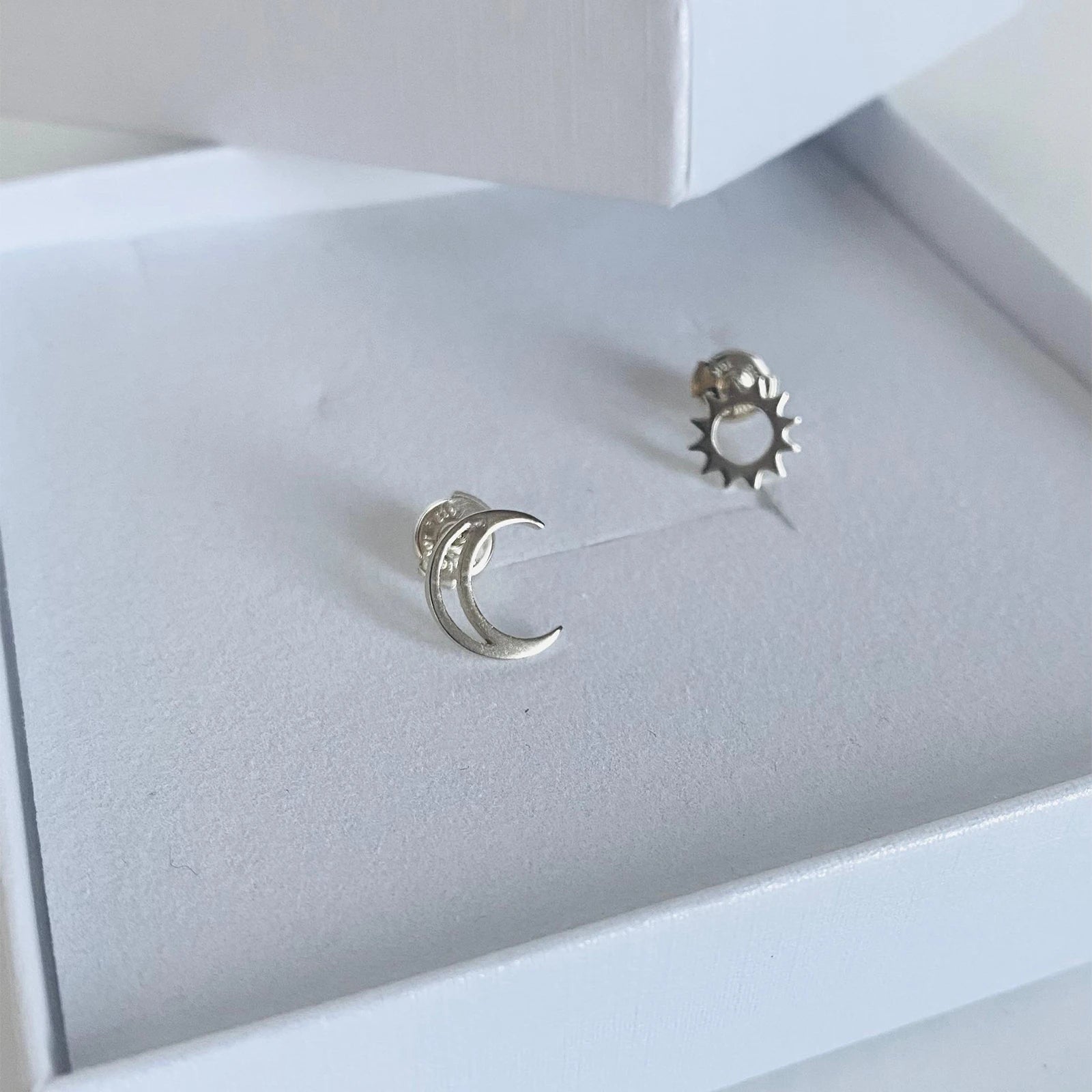 Luisana Jewelry Celestial Studs featuring moon and sun designs in silver on a display box