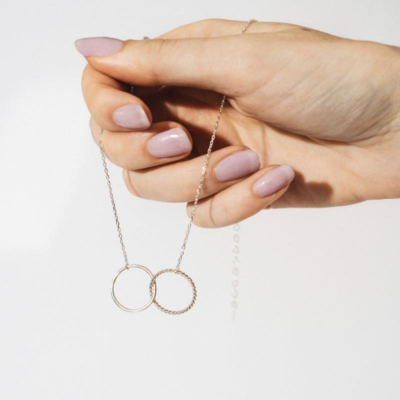 Delicate Cloe Necklace featuring intertwined rings on a silver chain for elegant style