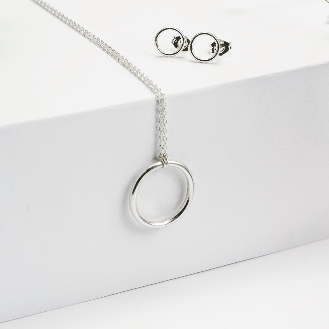 Luisana Jewelry Cloe Necklace with a sleek silver circle pendant on a delicate chain