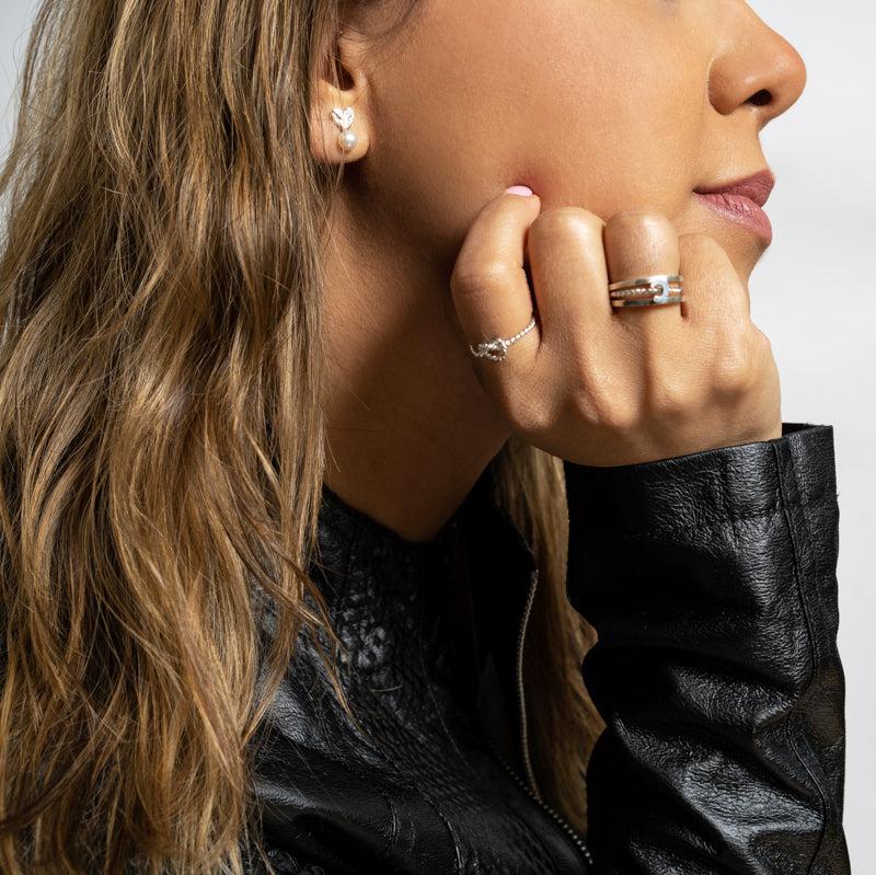 Stylish woman wearing a Luisana Jewelry Endless Ring alongside elegant earrings and a leather jacket