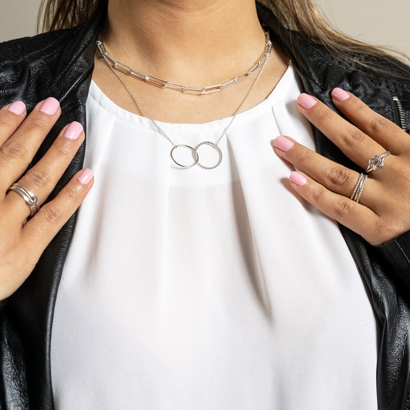 Woman wearing Luisana Jewelry Grecia Rings along with layered necklaces and bracelets for a stylish look