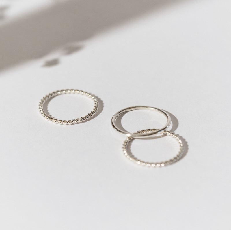 Grecia Rings set featuring three elegant silver bands in various textured designs