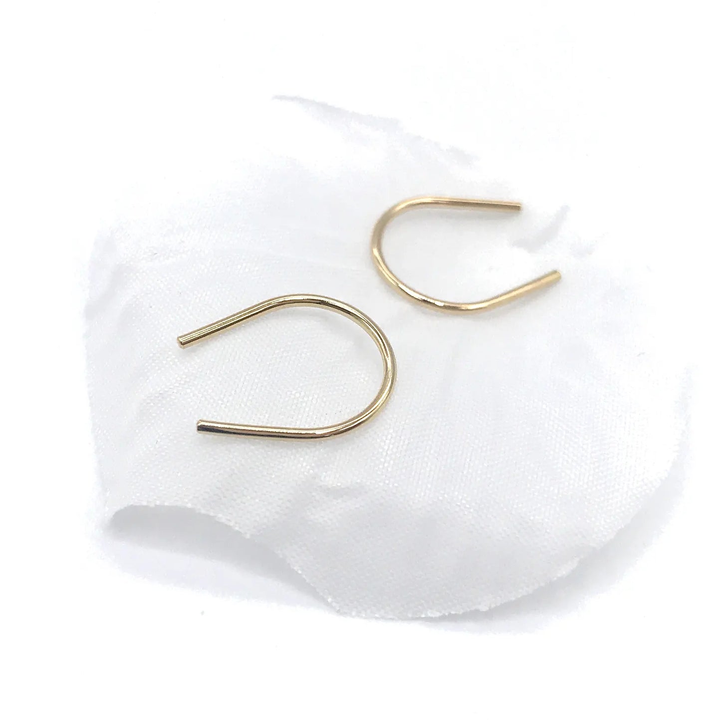 Gold horseshoe earrings designed with a minimalist style for elegant accessory options