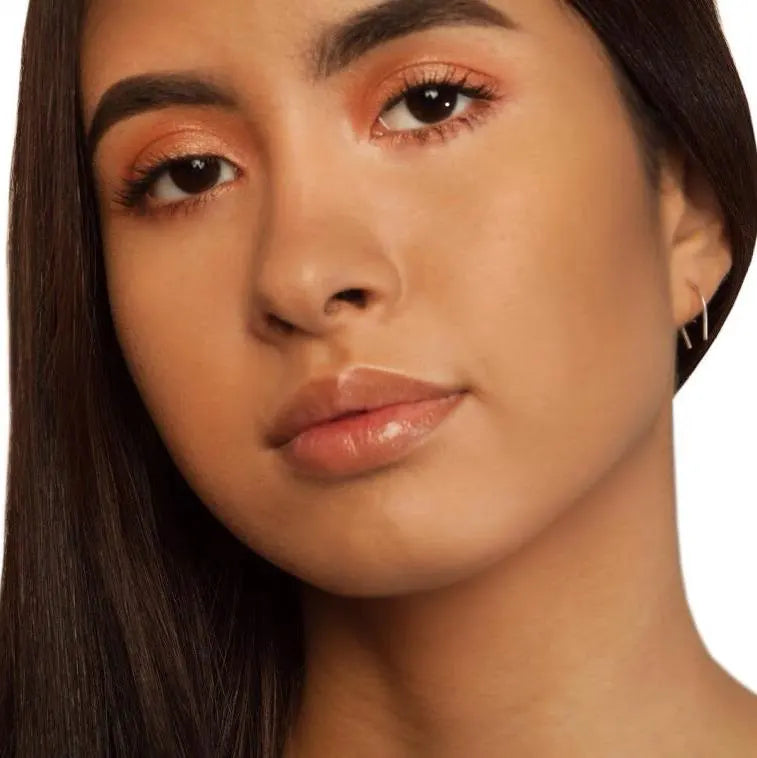 Luisana Jewelry horseshoe earrings displayed on a model with natural makeup and long hair