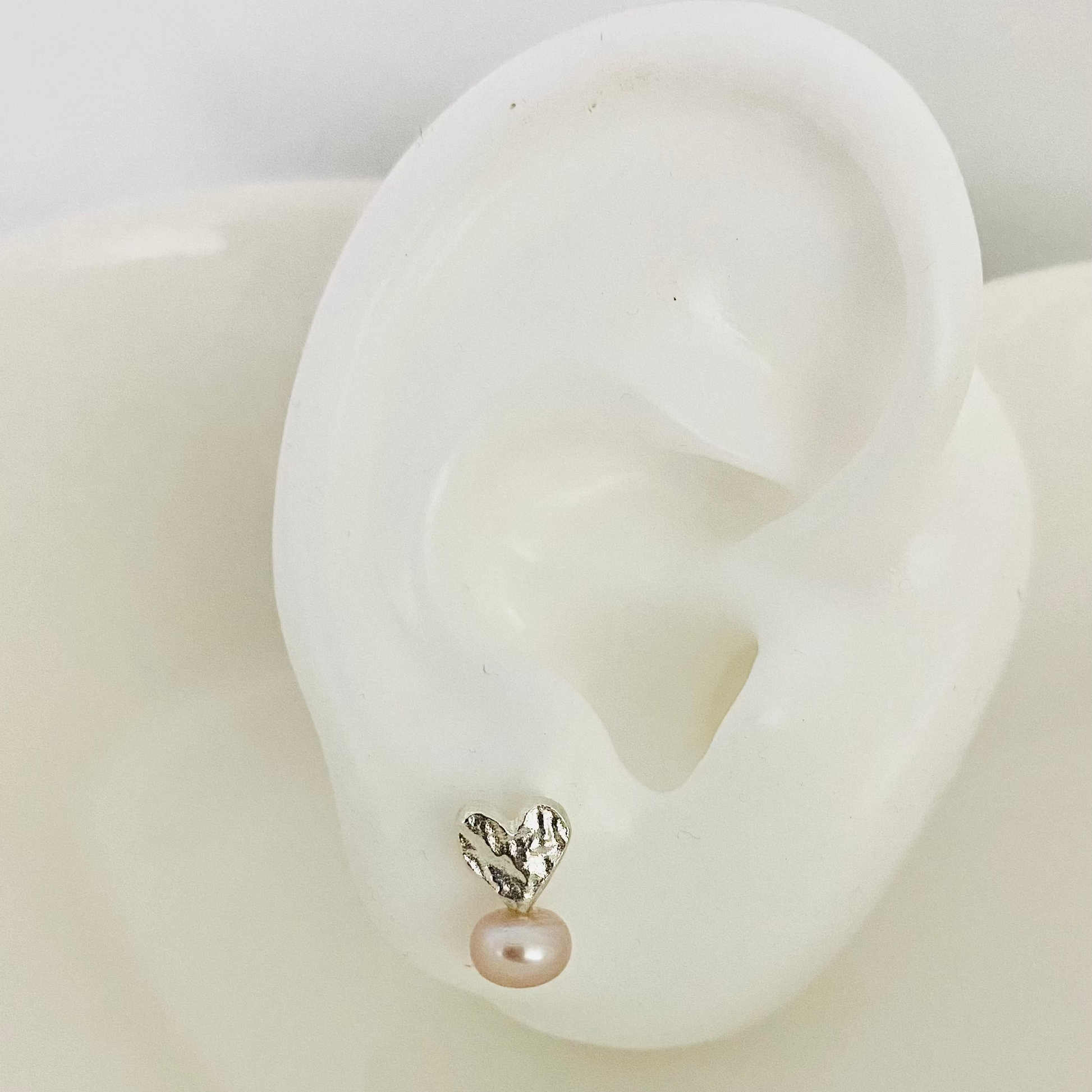 Elegant Lucy Studs Earrings featuring a heart design with a pearl accent for a stylish look