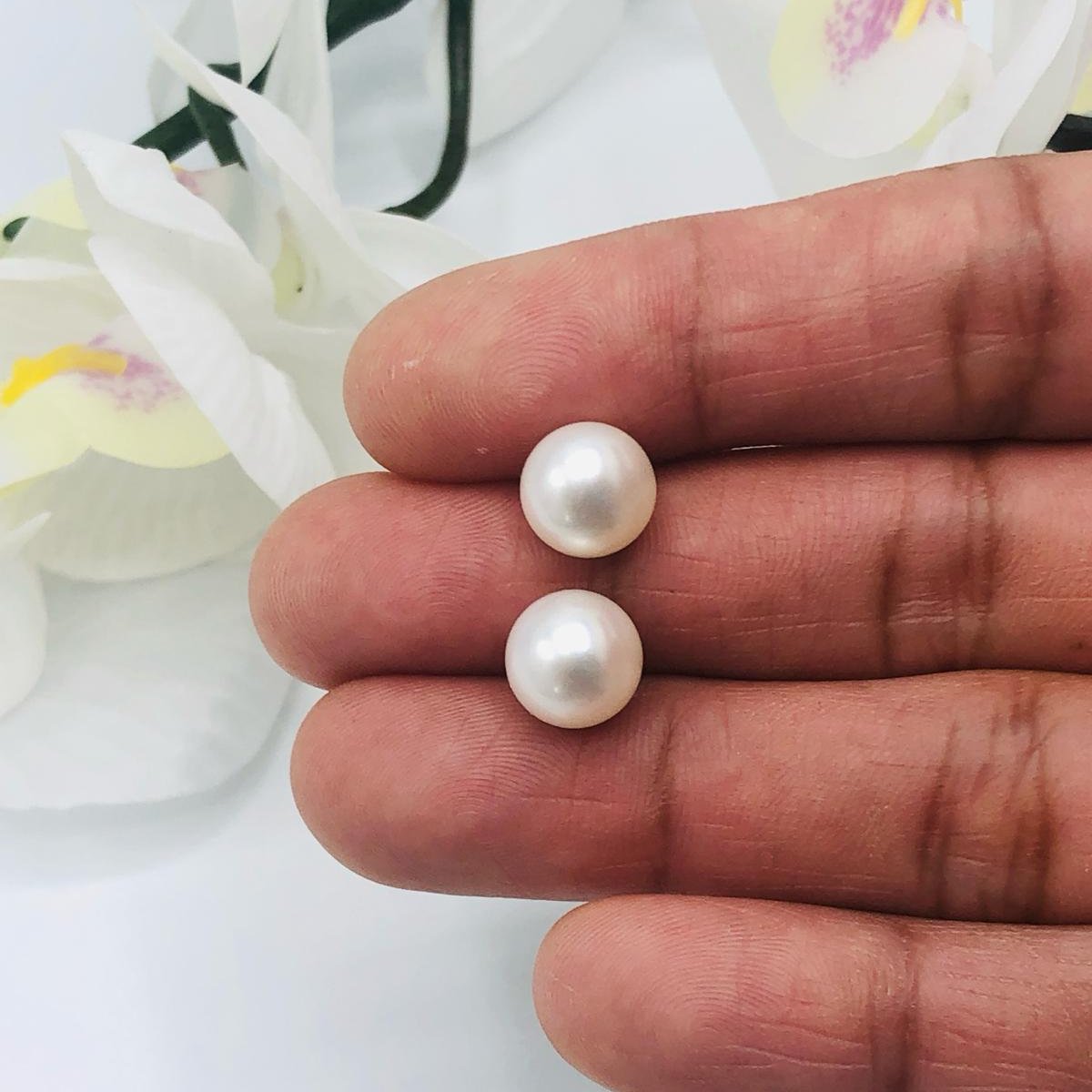 Luisana Jewelry Amelie Studs featuring elegant pearl design held in hand for a classy look