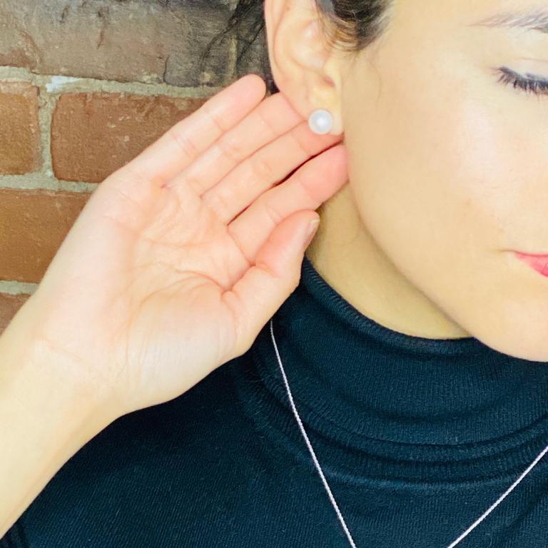 Woman wearing Luisana Jewelry Amelie Studs, elegant pearl earrings suitable for any occasion.