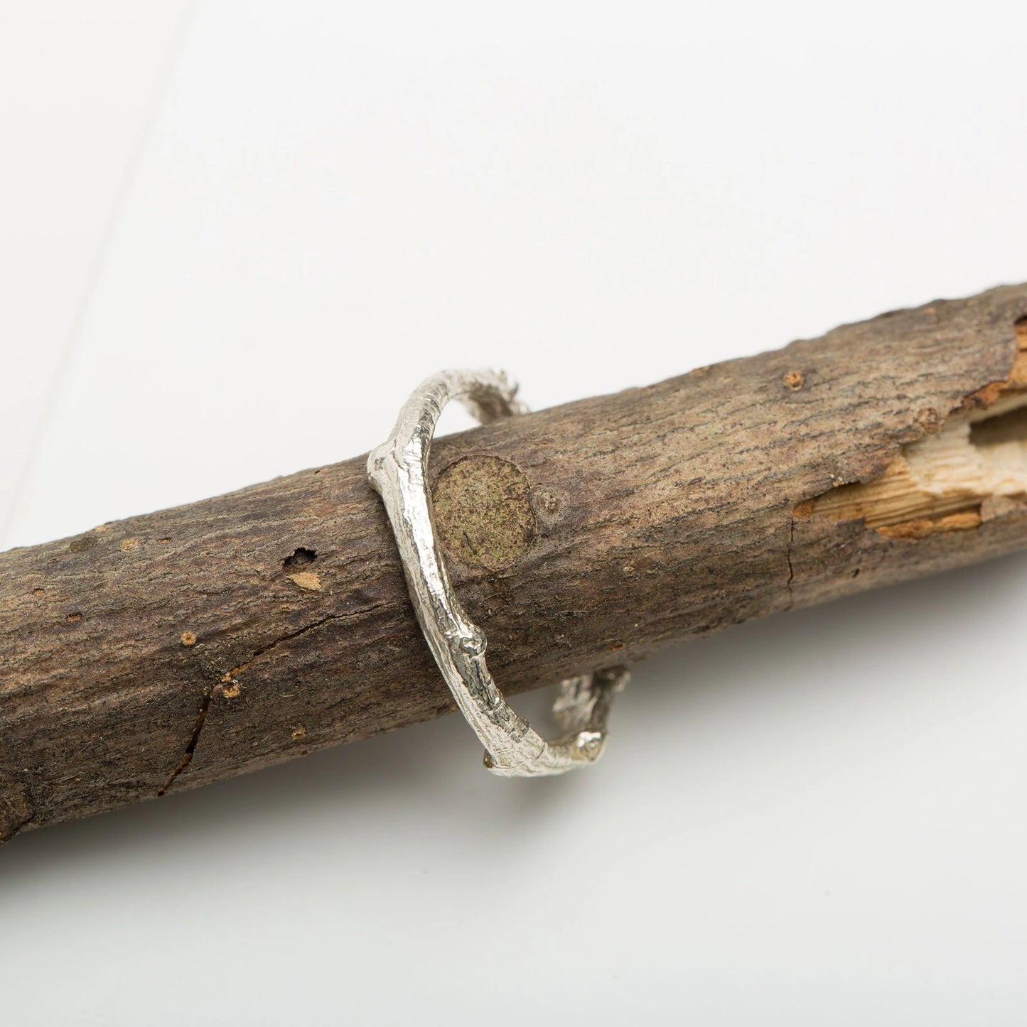 Luisana Jewelry Native Ring in Silver with a Unique Textured Design on a Natural Wood Background