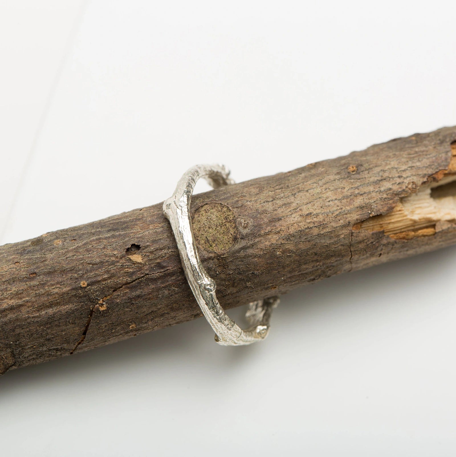 Luisana Jewelry Native Ring in Silver with a Unique Textured Design on a Natural Wood Background