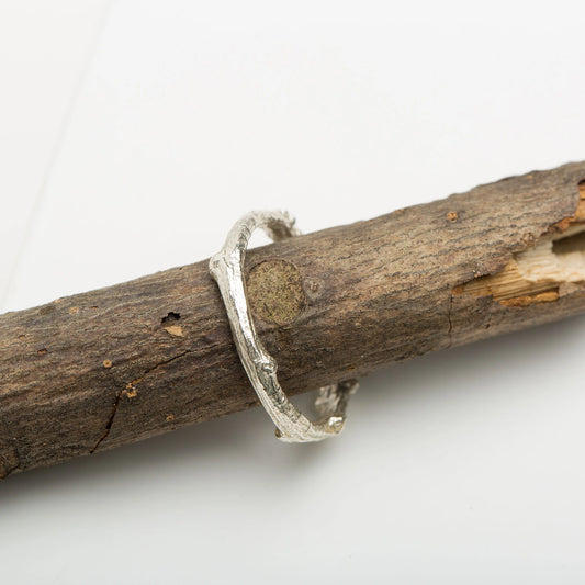 Luisana Jewelry Native Ring in Silver with a Unique Textured Design on a Natural Wood Background