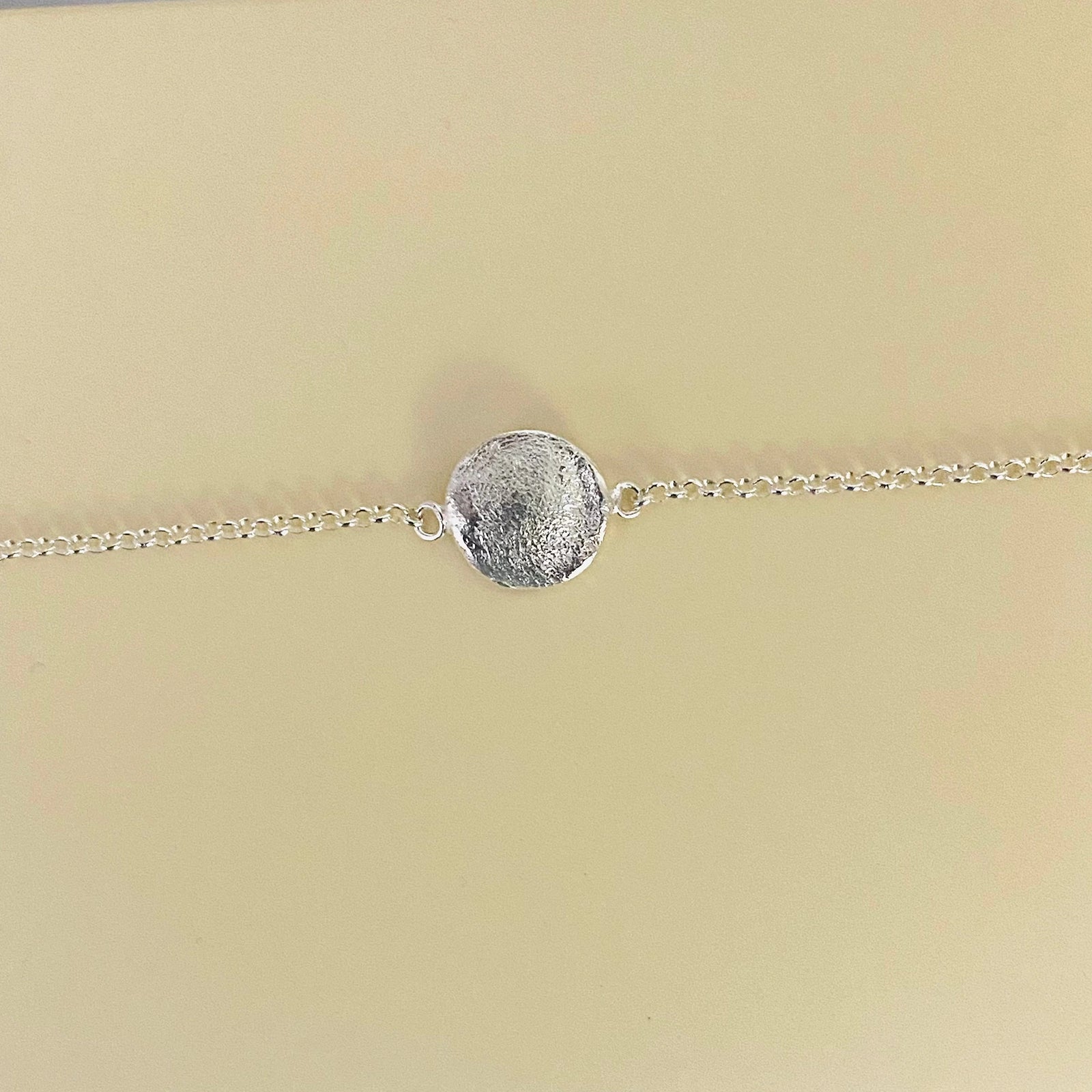 Delicate Luisana Jewelry Organic Love Bracelet with a textured circular pendant in silver