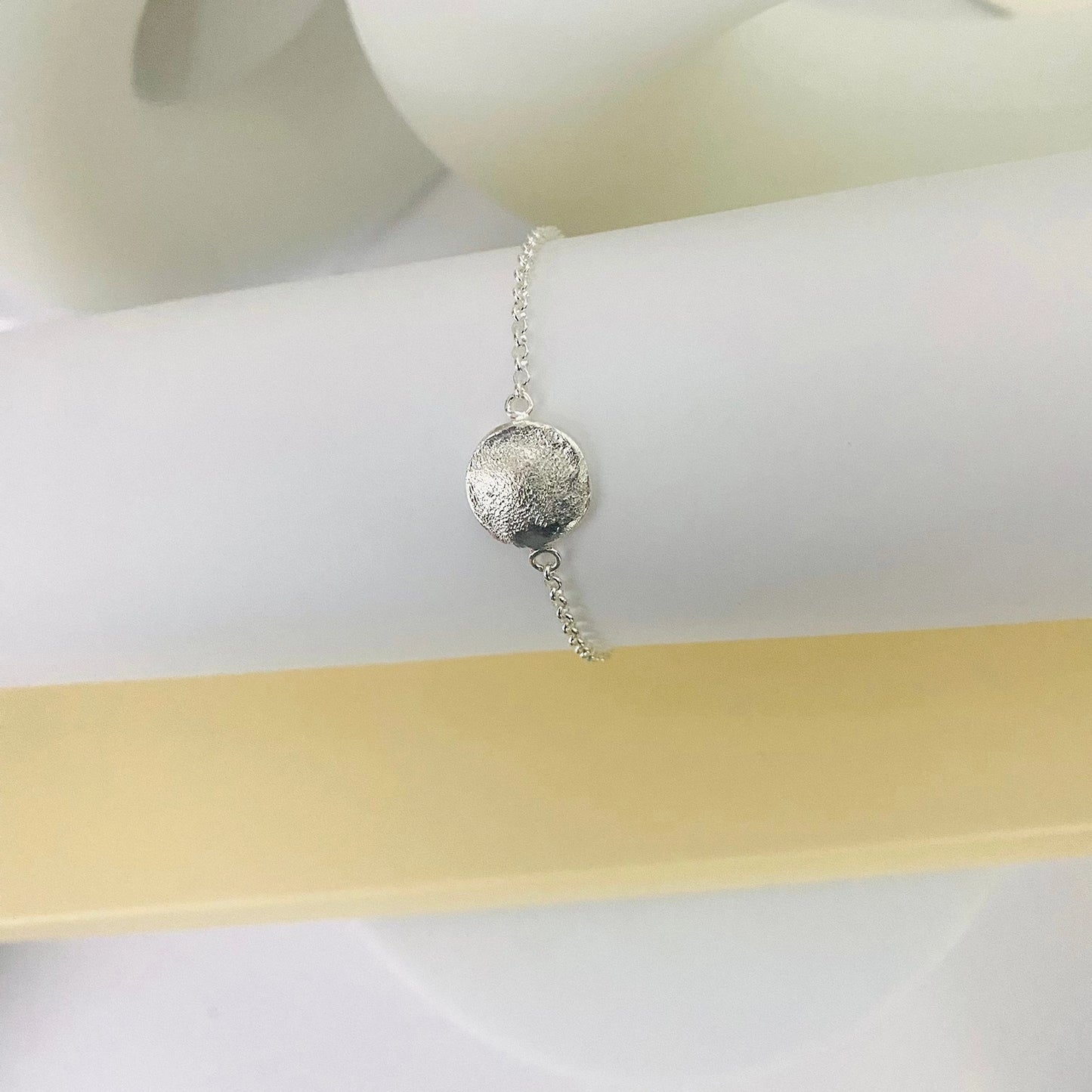 Luisana Jewelry Organic Love Bracelet with a textured silver charm on a delicate chain