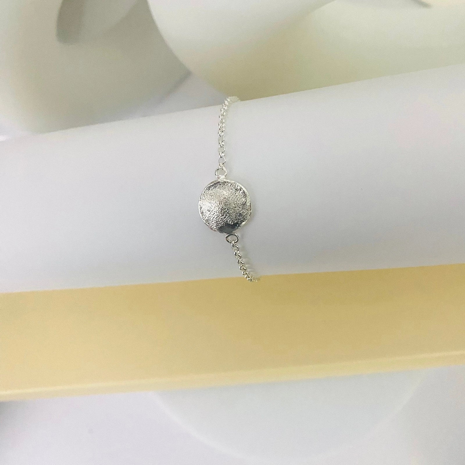 Luisana Jewelry Organic Love Bracelet with a textured silver charm on a delicate chain