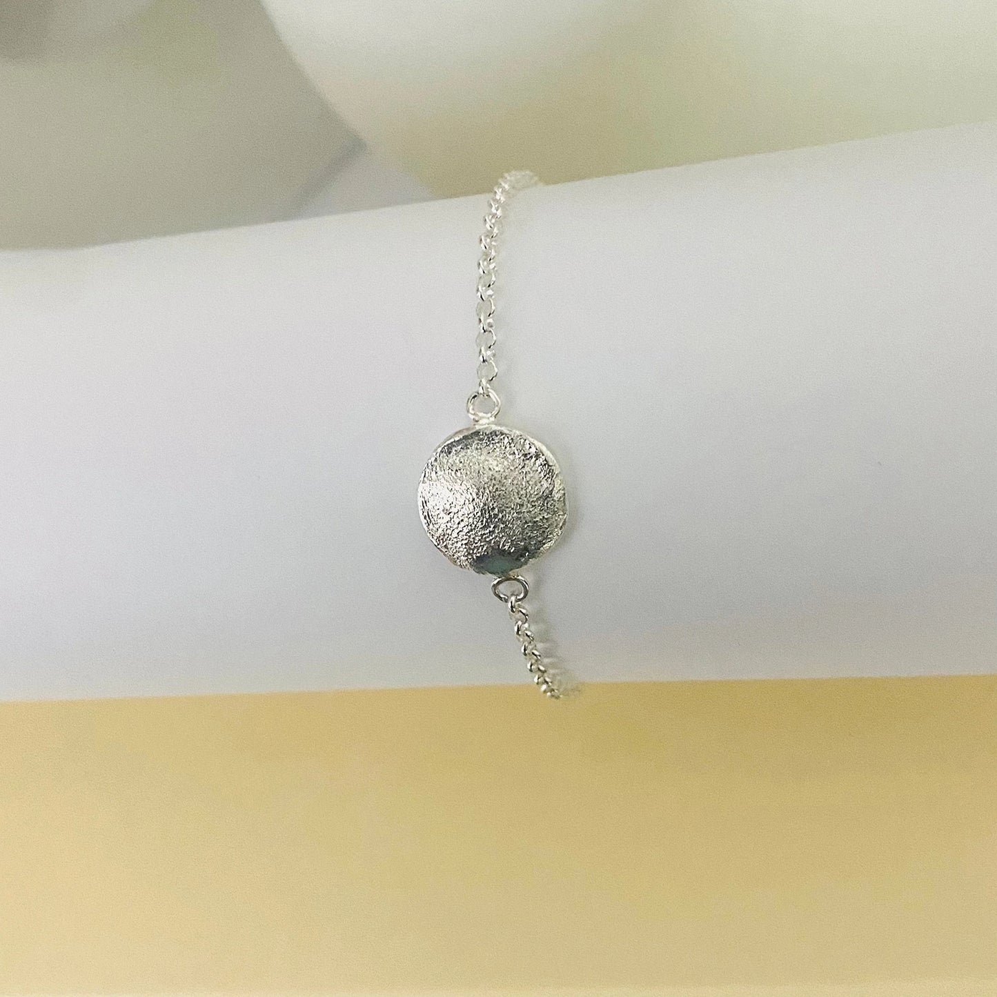 Luisana Jewelry Organic Love Bracelet featuring a textured silver charm on a delicate chain
