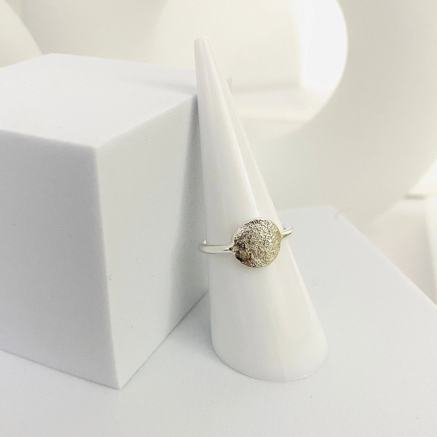 Luisana Jewelry Organic Love Ring with a textured design displayed on a cone-shaped ring holder