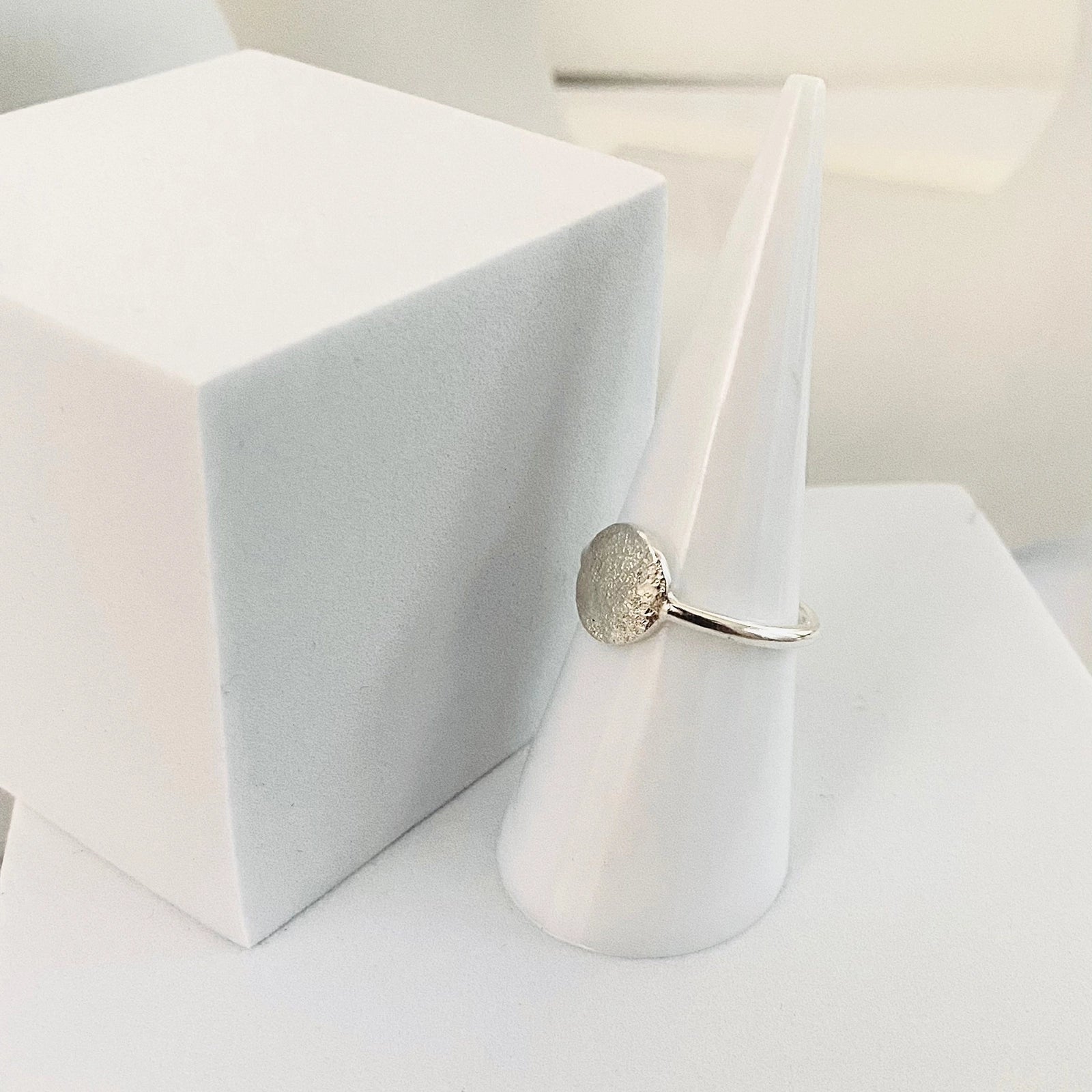 Luisana Jewelry Organic Love Ring displayed on a geometric ring holder for a modern look