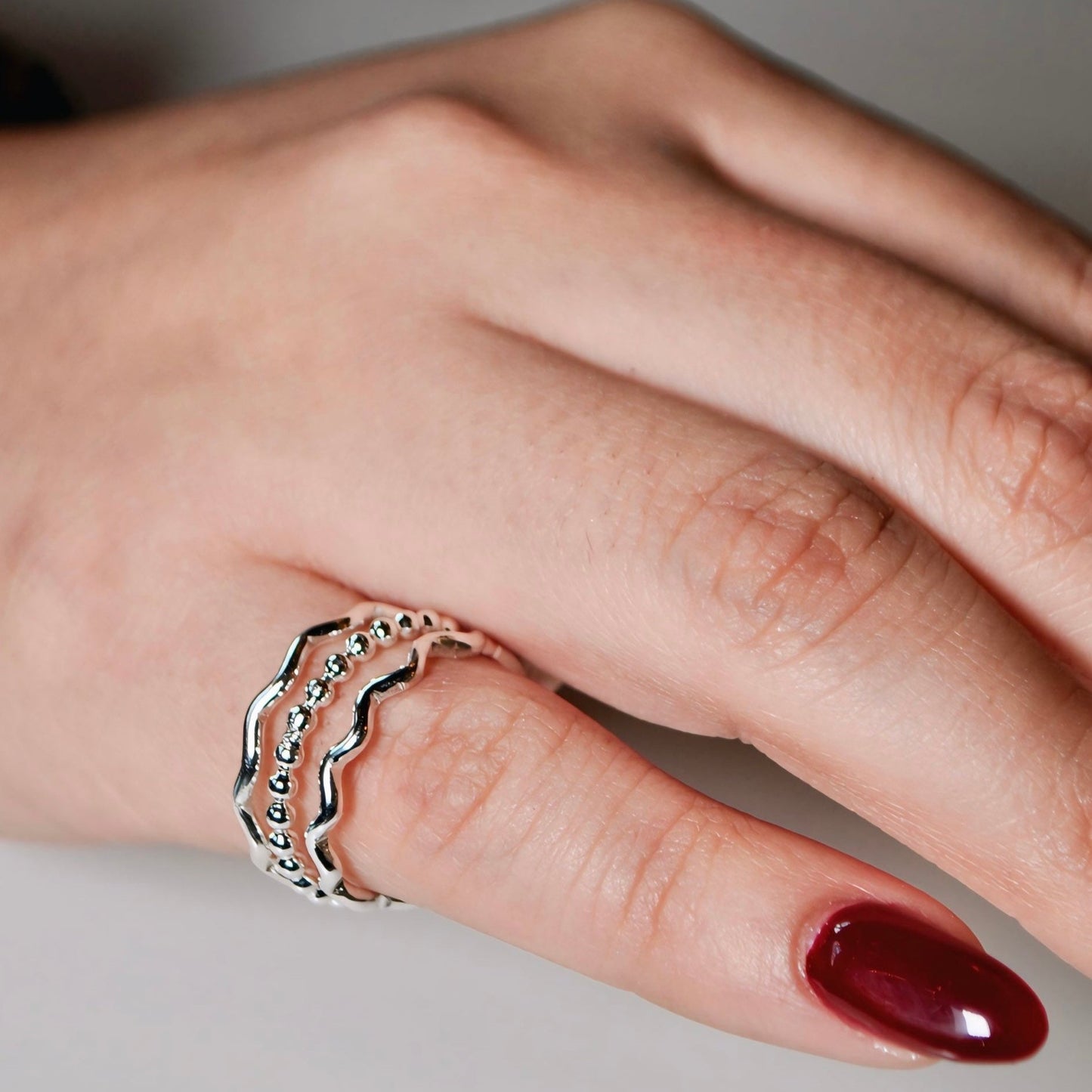 Stylish silver Santorini Rings featuring wavy design and bead accents for a modern look