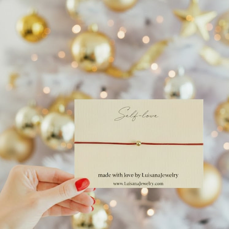 self_ love bracelet in red with 14k gold bead