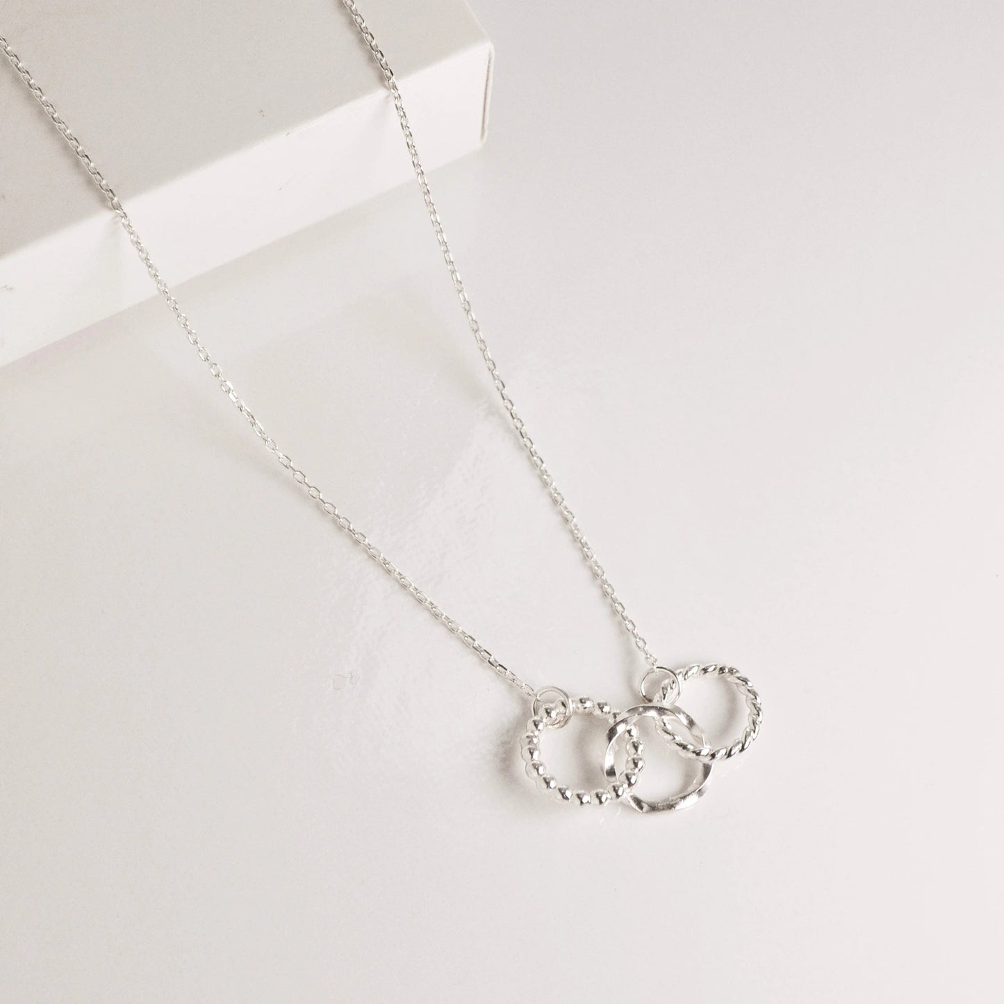 Luisana Jewelry trio necklace with three textured rings on a delicate silver chain