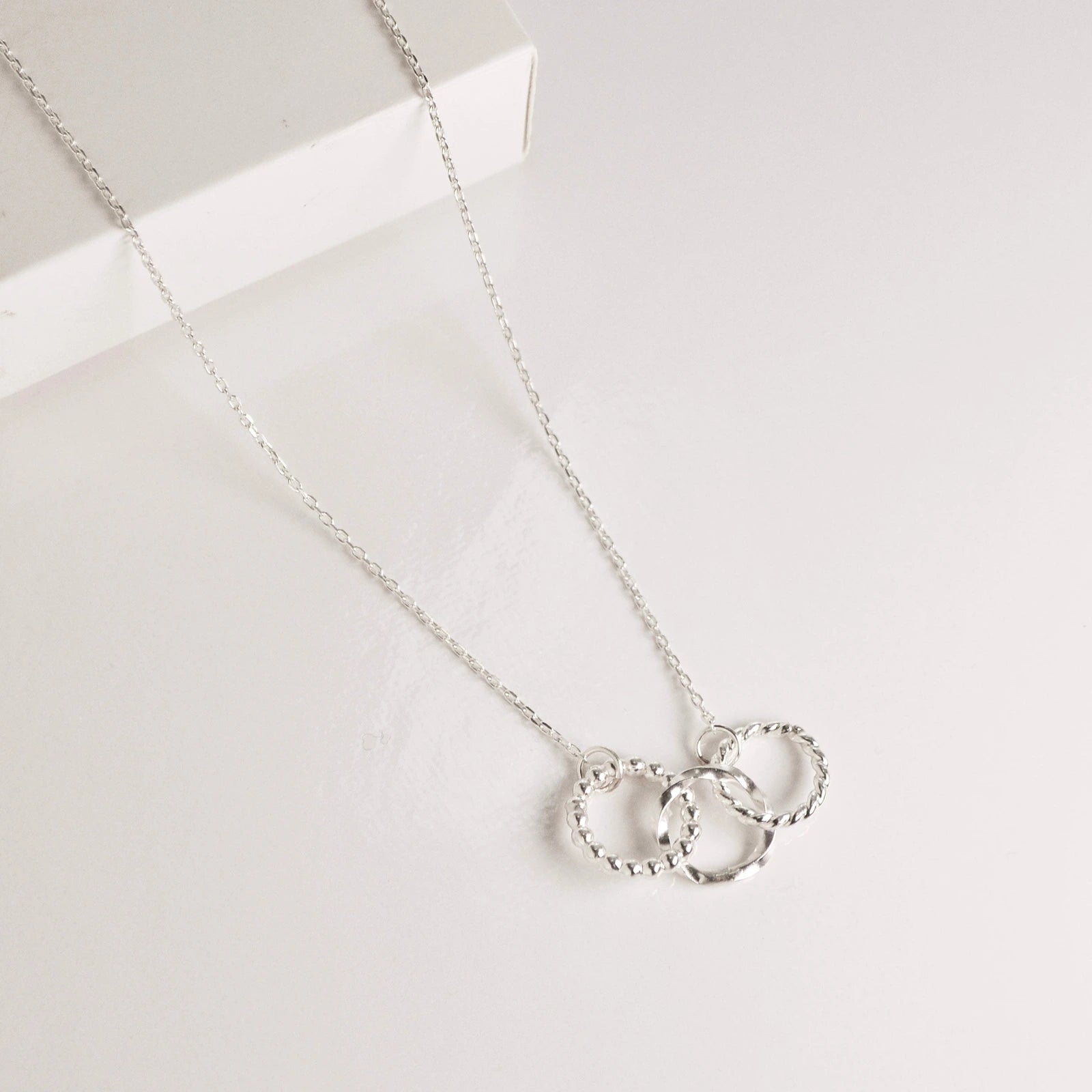Luisana Jewelry trio necklace with three textured rings on a delicate silver chain