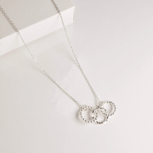 Luisana Jewelry trio necklace with three textured rings on a delicate silver chain