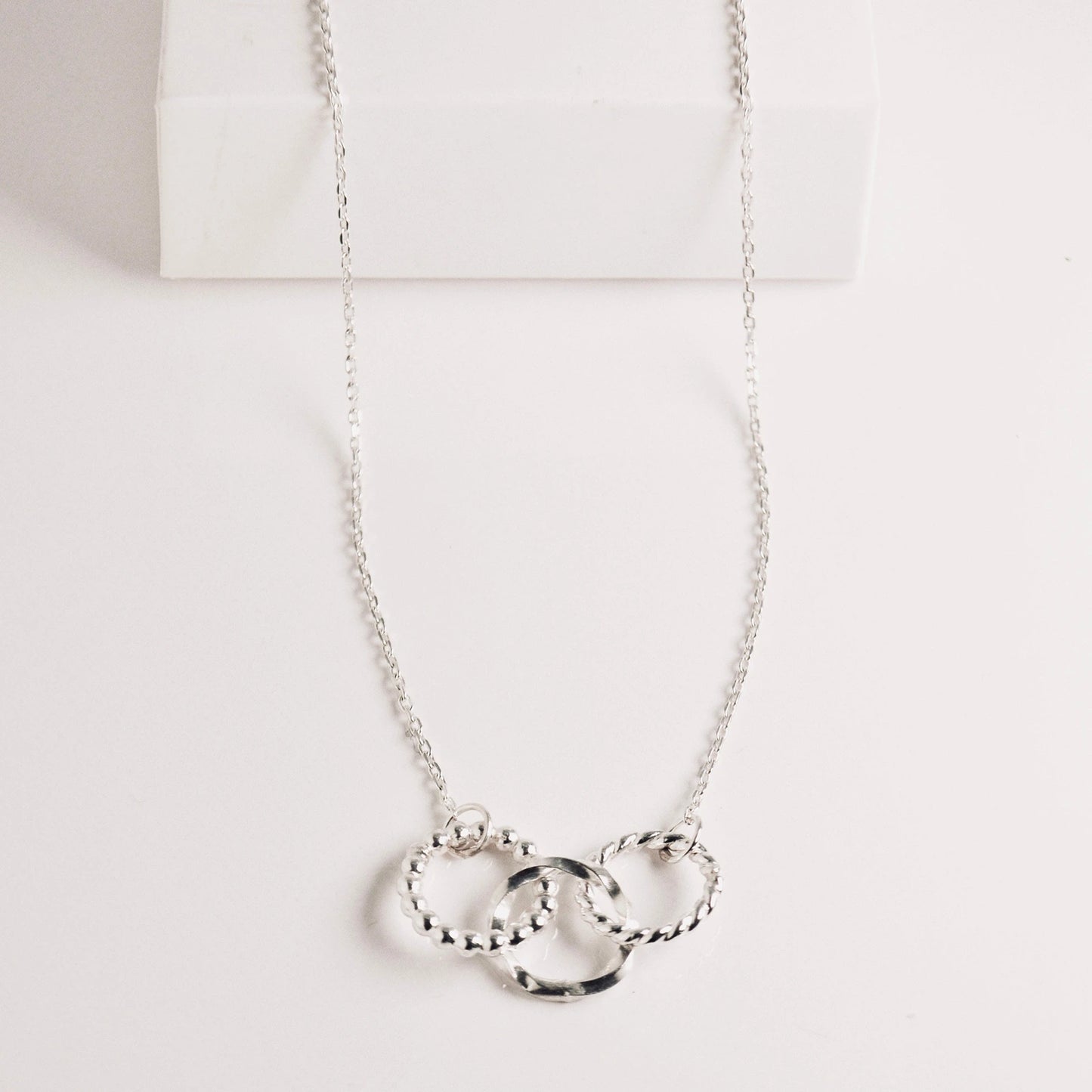 Luisana Jewelry trio necklace featuring three intertwined silver rings on a delicate chain