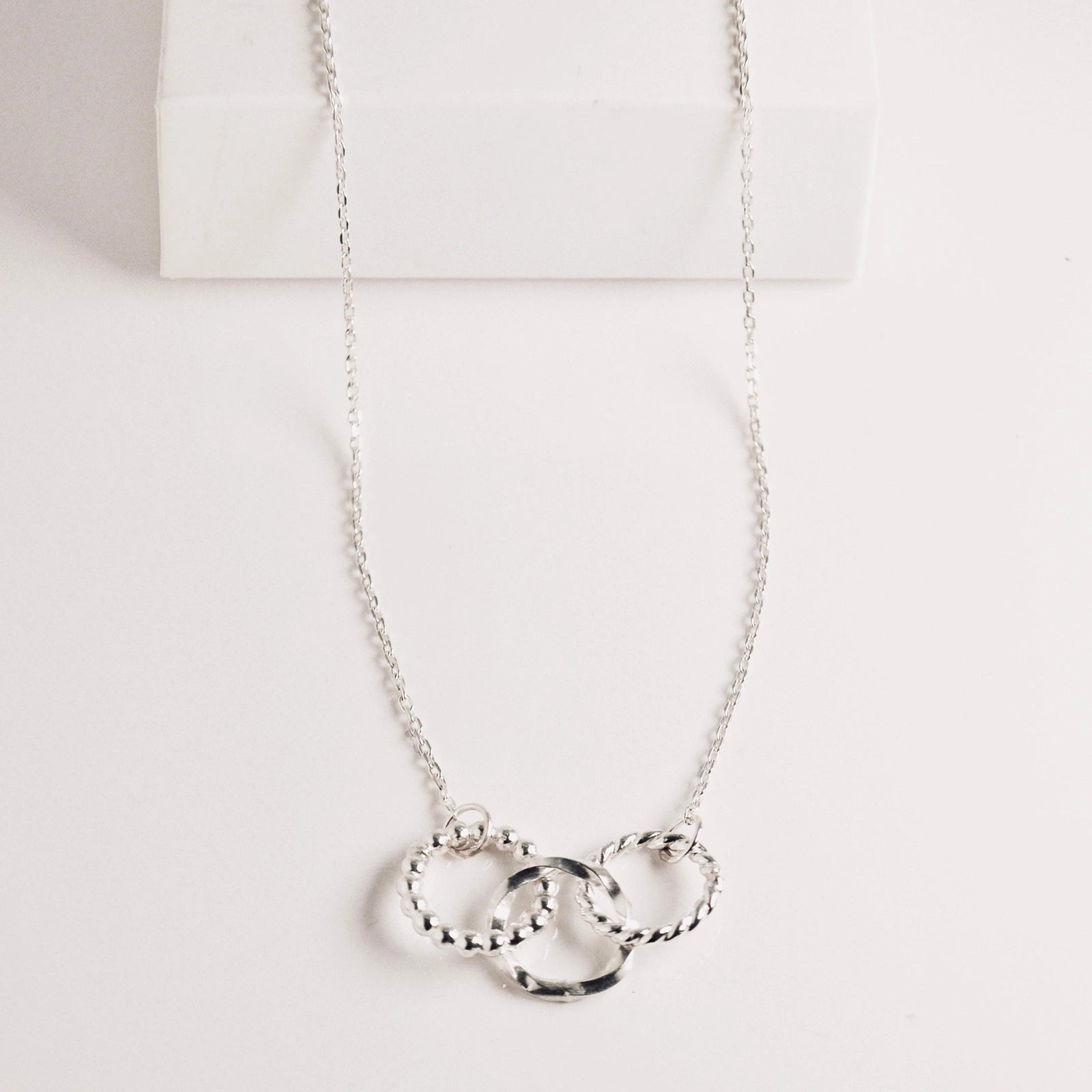 Luisana Jewelry trio necklace featuring three intertwined silver rings on a delicate chain