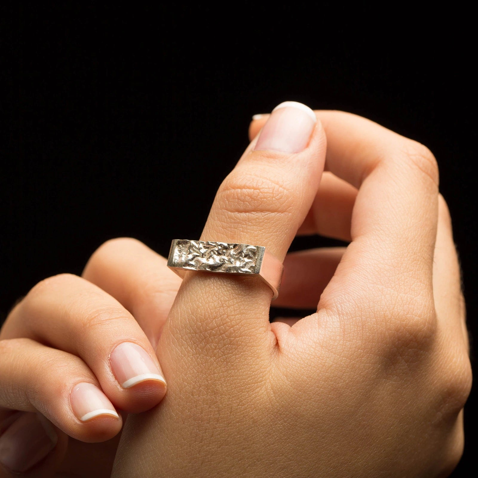 Stylish Luisana Jewelry Terra Ring with a unique textured design on a hand model