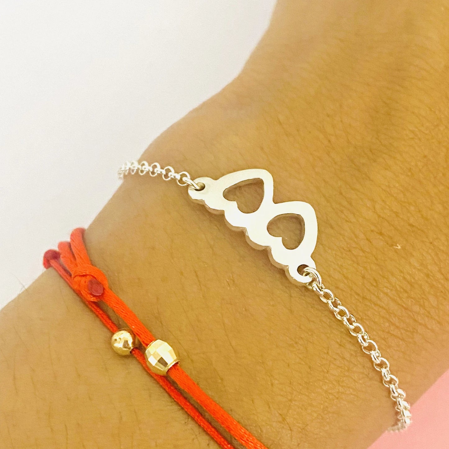 Luisana Jewelry two hearts bracelet designed with a delicate silver chain and red cord detail