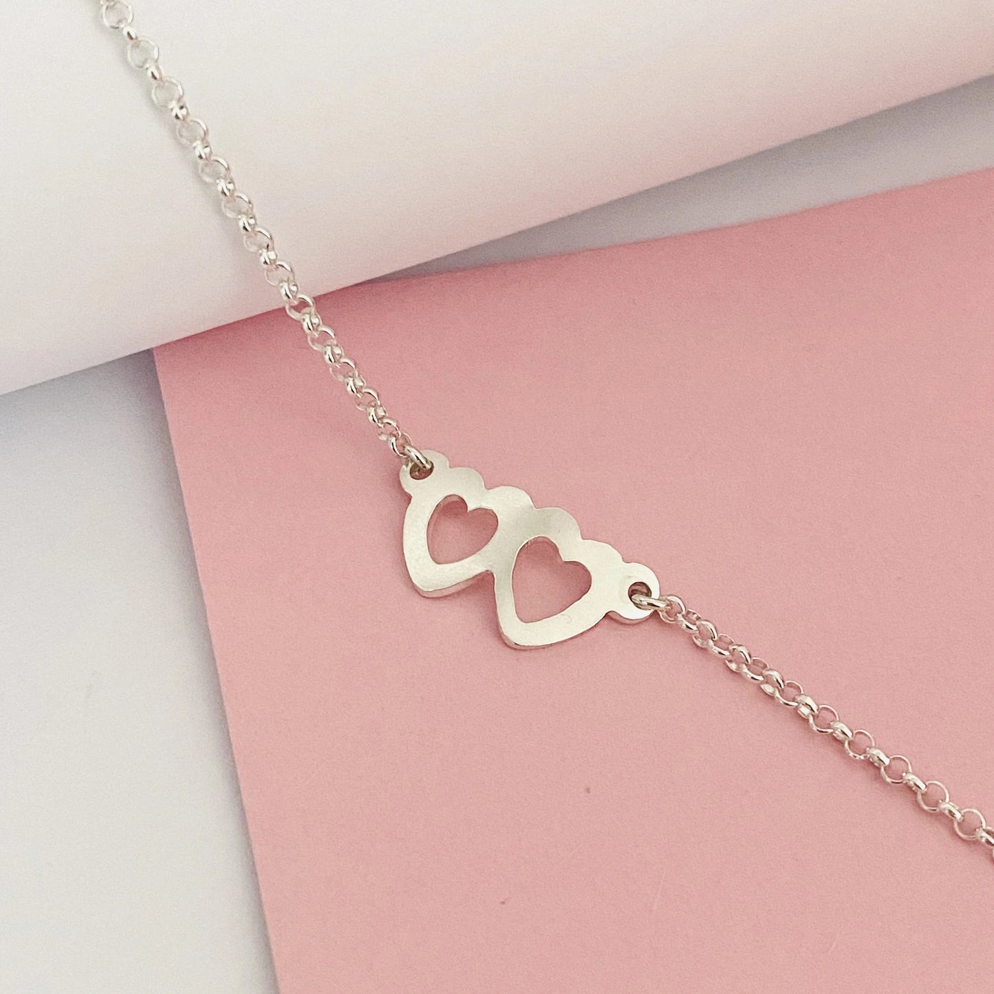 Luisana Jewelry two hearts bracelet in silver with a minimalist design featuring two heart charms