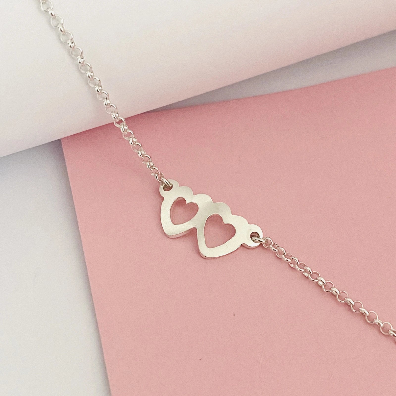 Luisana Jewelry two hearts bracelet in silver with a minimalist design featuring two heart charms