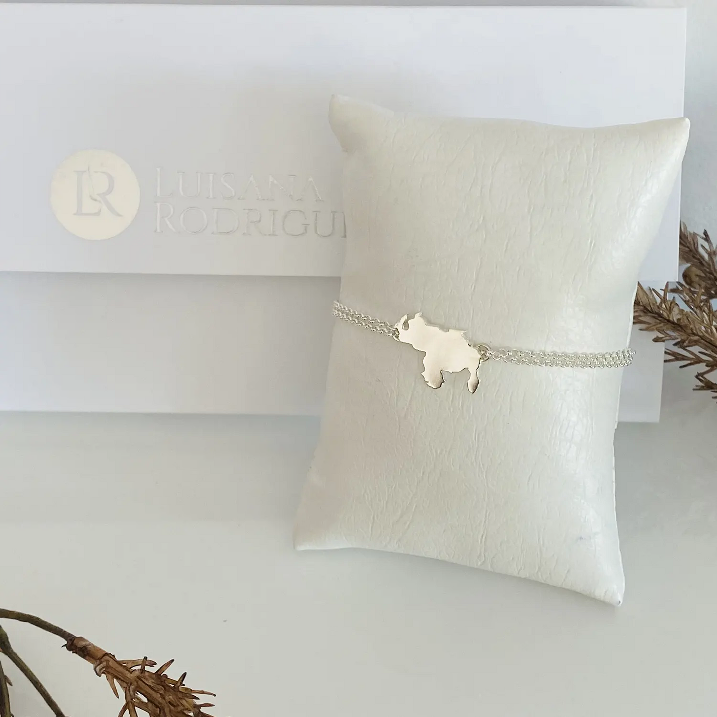 Venezuela bracelet solid from Luisana Jewelry with delicate design on a plush display pillow